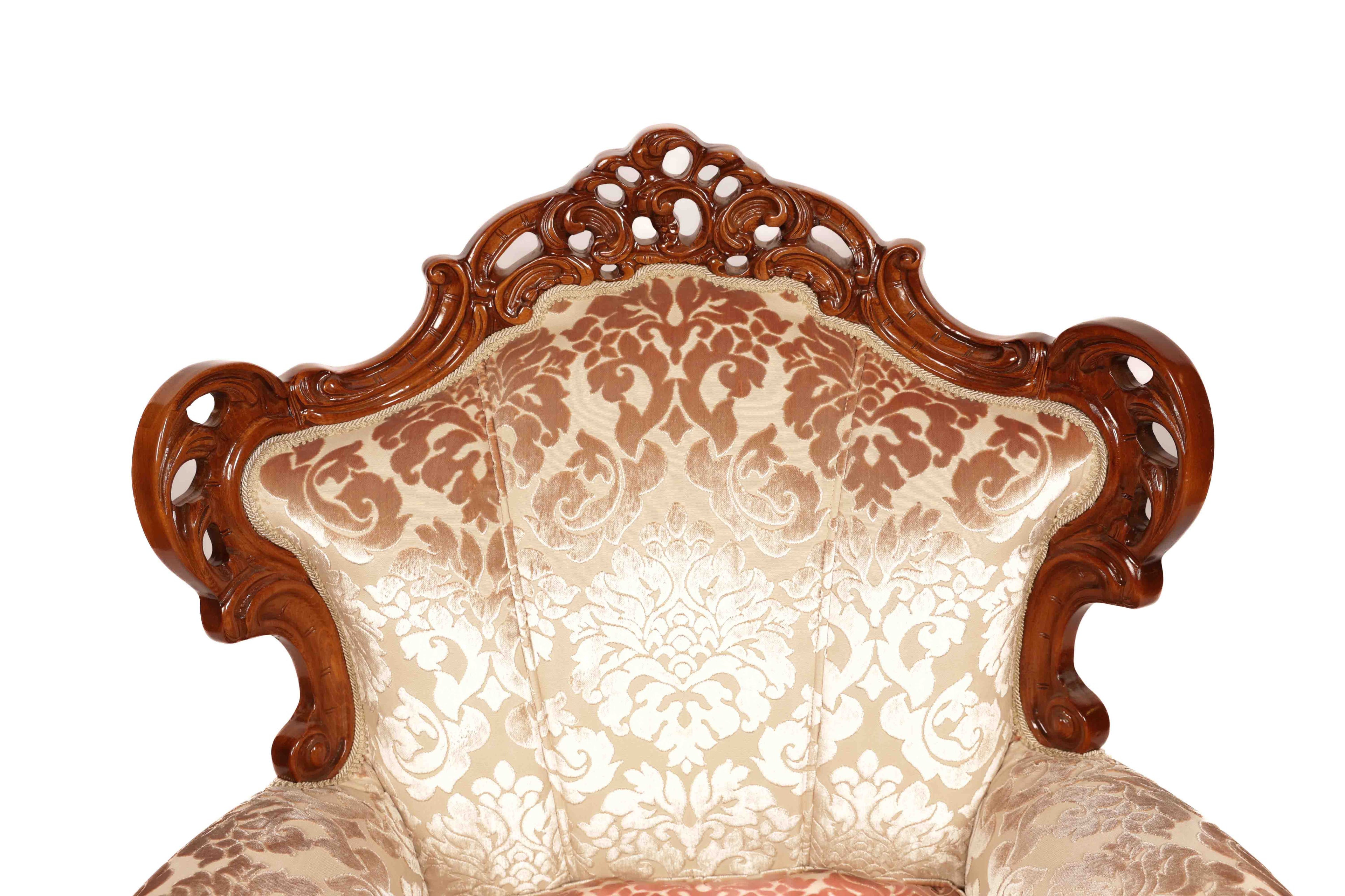 Decorative armchair with intricate wooden backrest and floral-patterned upholstery 