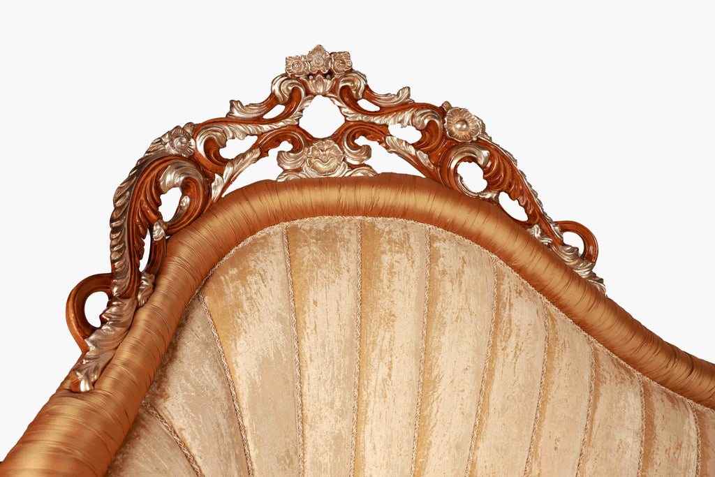 Close-up of an ornate wooden headboard with intricate carvings
