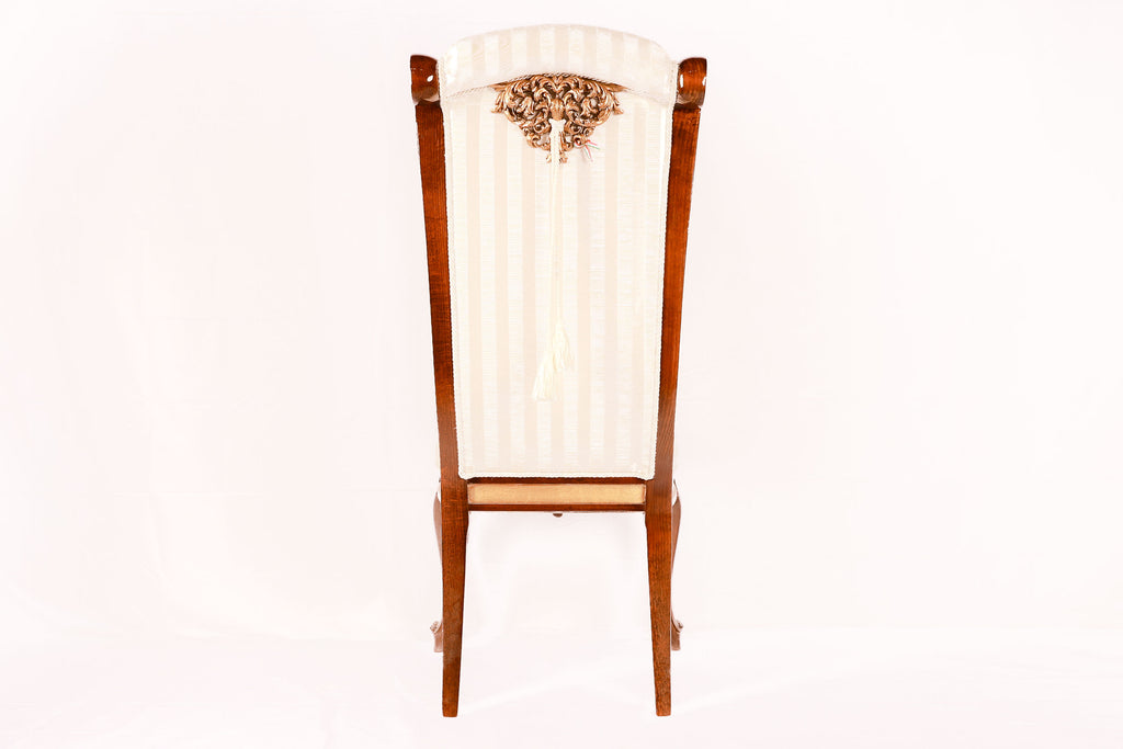 Decorative chair with a white cushion and wooden frame