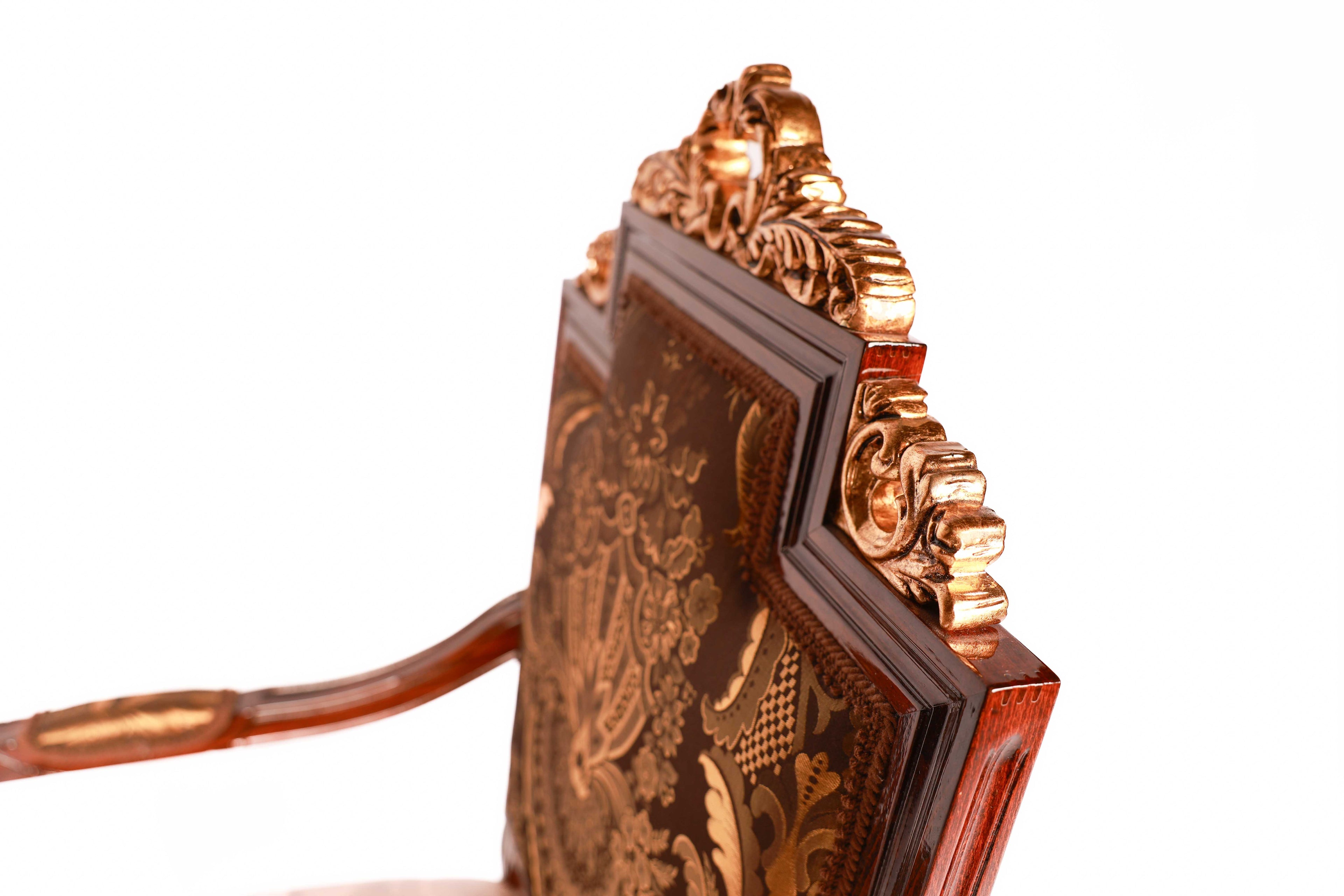 Decorative wooden chair with intricate carvings and gold accents 