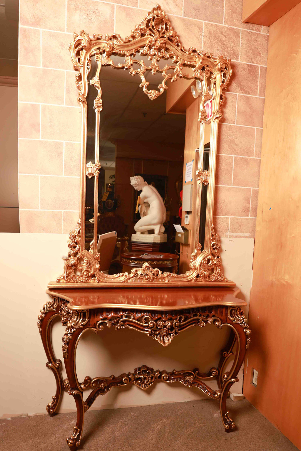 Decorative wooden console table with an ornate mirror