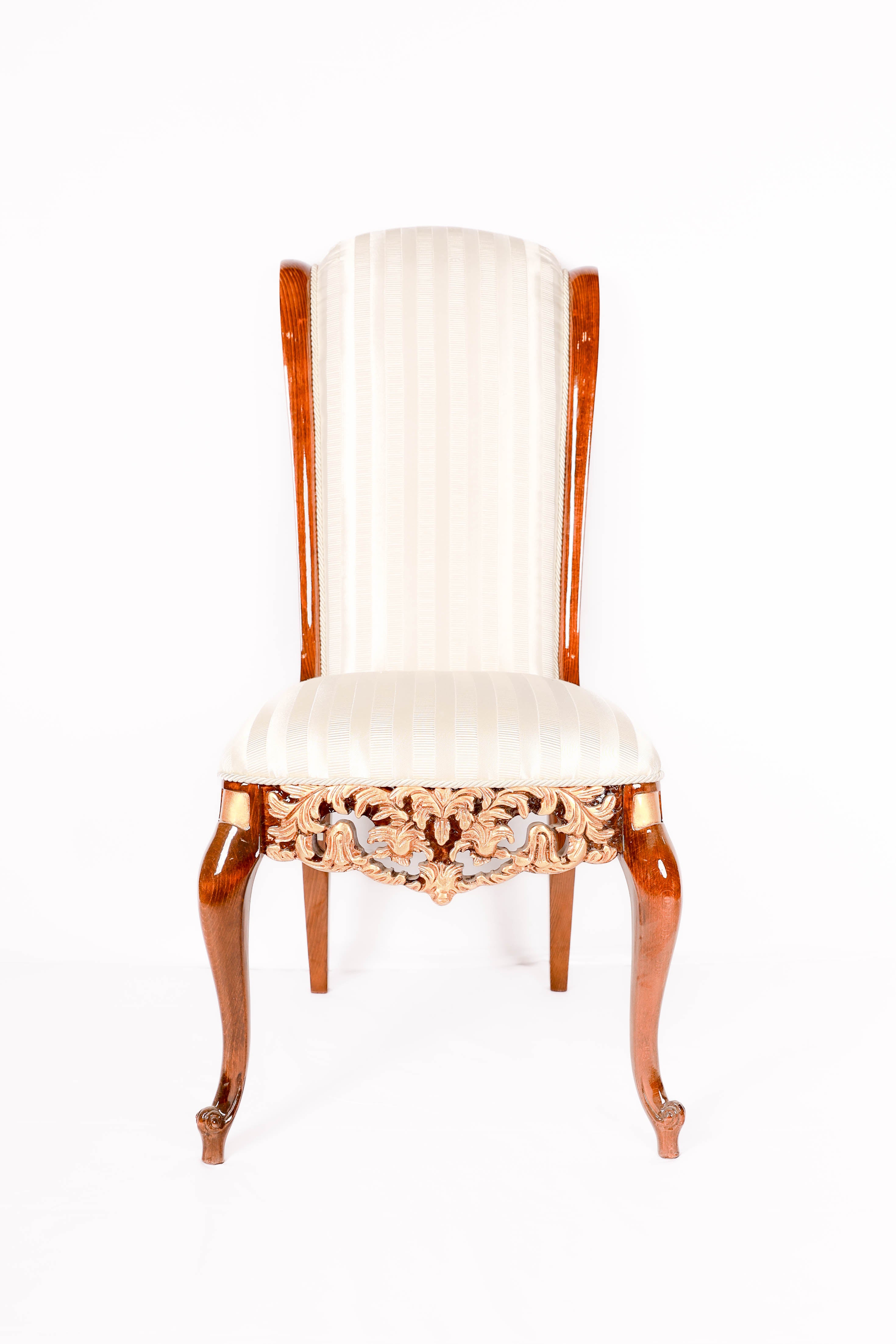 Decorative chair with white cushion and gold lace detailing 