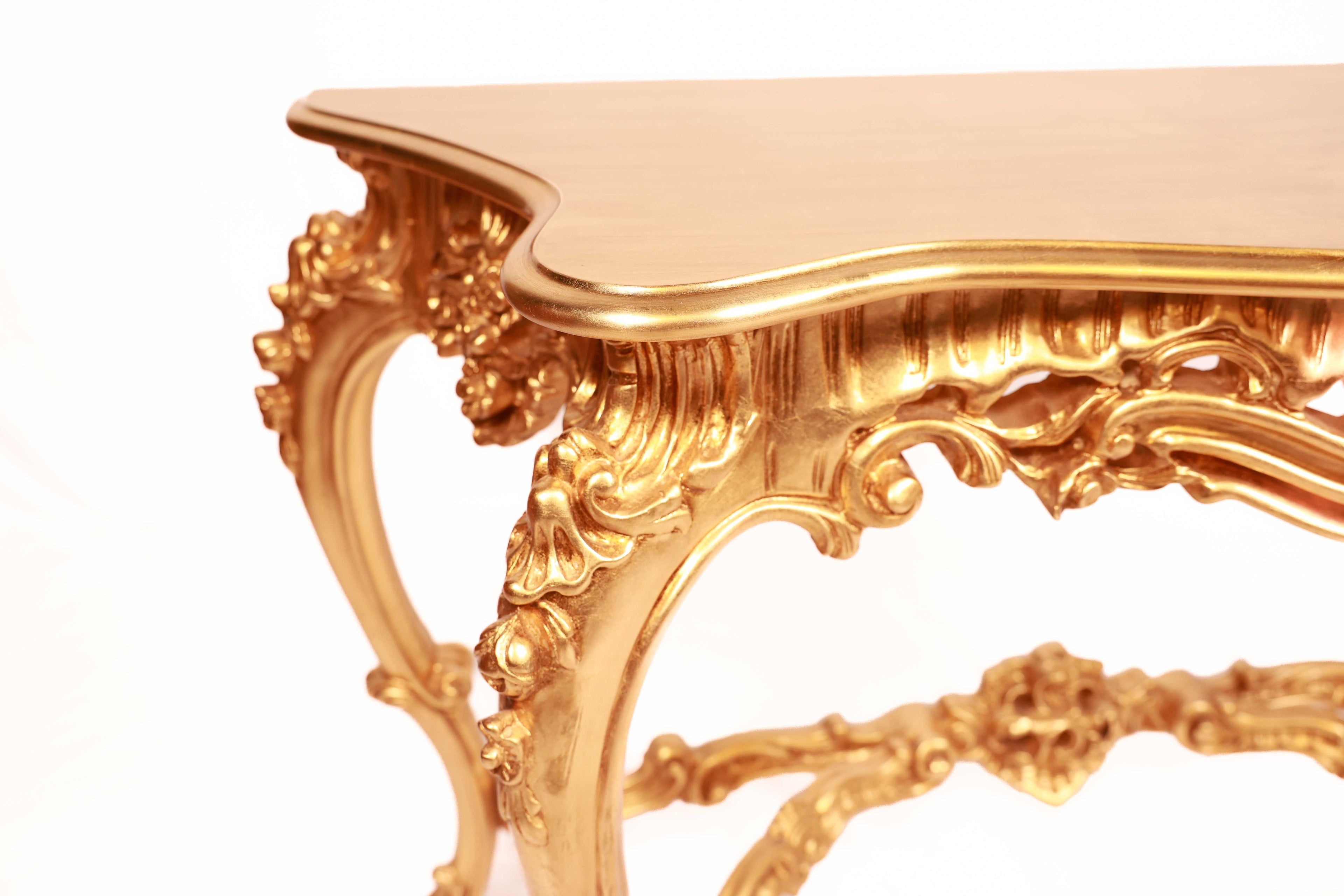 Gold ornate table with intricate designs 