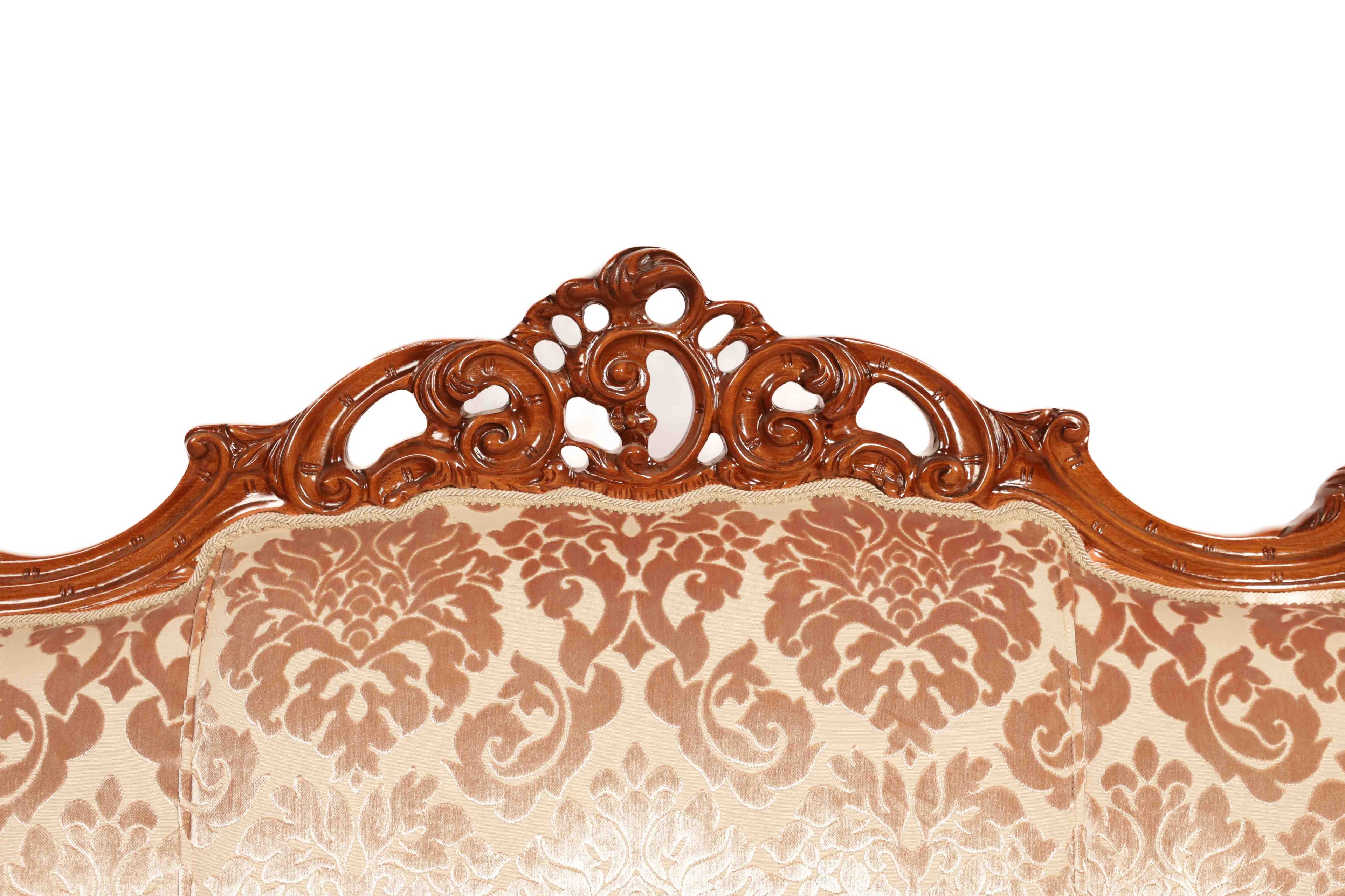 Carved wooden headboard with floral patterned fabric