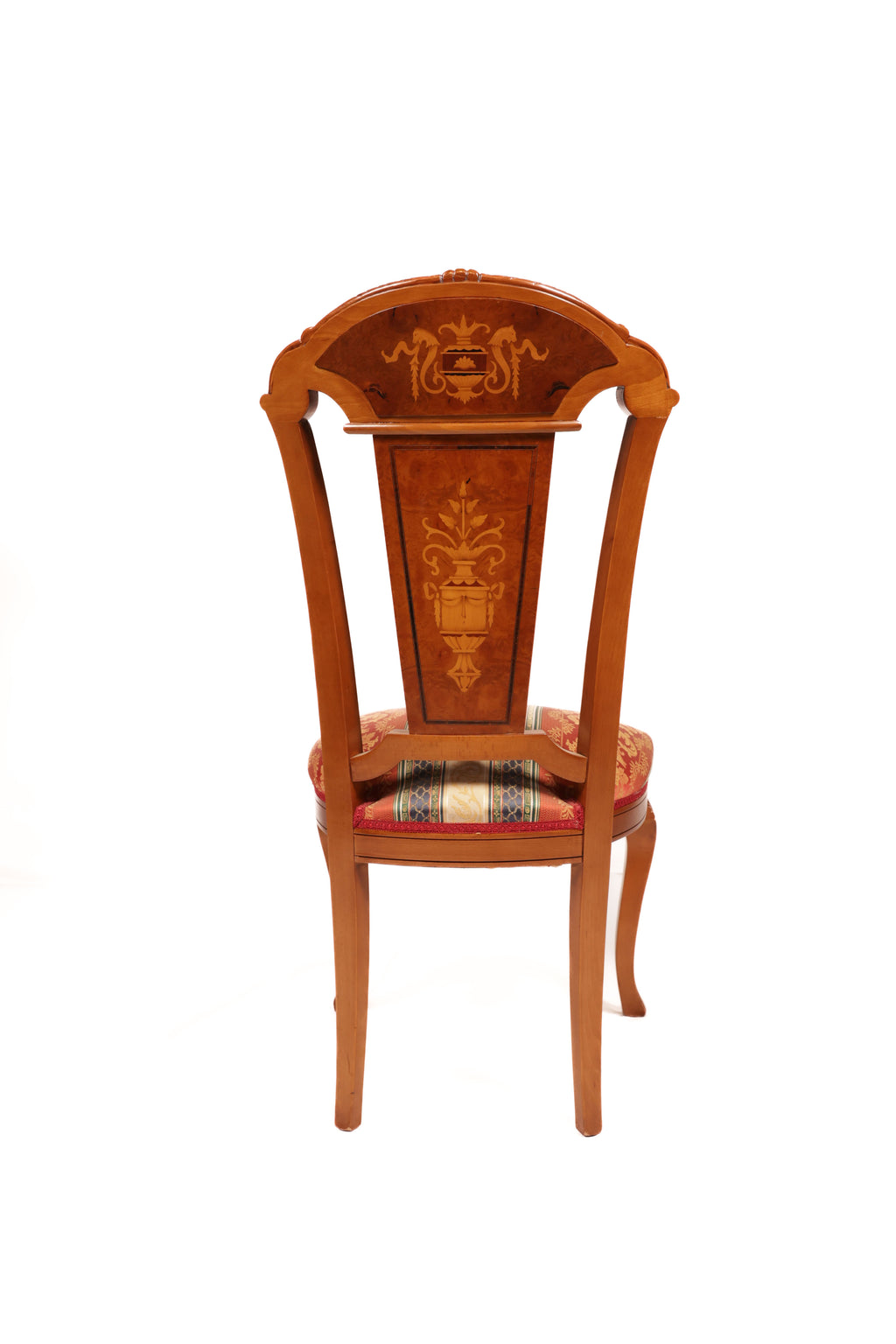 Wooden chair with intricate carvings and a patterned cushion